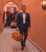 Handmade brown kilim travel bag crafted from genuine leather and vintage Moroccan kilim textile.