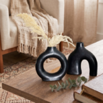 Double black ceramic vase set with matte finish displayed on white marble surface