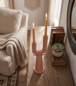 Dual branch ceramic vase holding dried pampas grass and eucalyptus stems on a wooden shelf