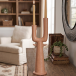 Dual branch ceramic vase with two curved necks on a white marble surface