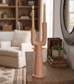 Dual branch ceramic vase with two curved necks on a white marble surface