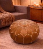 Handmade Moroccan leather pouf with intricate white starburst embroidery