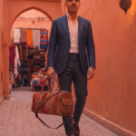 Woman carrying Moroccan kilim leather duffel bag brown over shoulder at airport, luxury handcrafted Berber travel bag from Marrakech Morocco