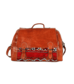 Handmade Moroccan kilim travel bag in brown genuine leather and traditional handwoven Berber carpet fabric with solid brass hardware, crafted in Marrakech Morocco