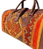 Close-up of authentic Moroccan brown leather bag showing saddle stitch detail, beeswax burnished edges and antique brass clasp hardware