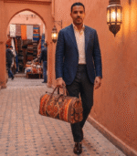 Woman carrying authentic Moroccan handcrafted brown leather shoulder bag in medina street, genuine leather artisan bag from Marrakech Morocco
