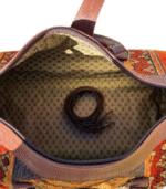 Interior of authentic Moroccan brown leather bag showing premium cotton lining multiple pockets and brass zipper compartment, handcrafted in Morocco