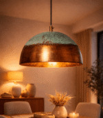 Oxidized metal table lamp with antique bronze finish on a wooden side table