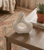 Cream ceramic vase with sculptural cut-out design and sage green hand-painted details