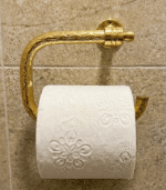 Hand-engraved unlacquered brass toilet paper holder with artisan detailing