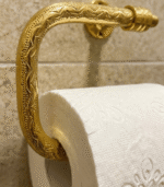 Hand-engraved unlacquered brass toilet paper holder with artisan detailing