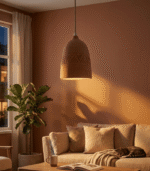 Handmade terracotta pendant light with matte clay dome shade on white ceiling over marble surface